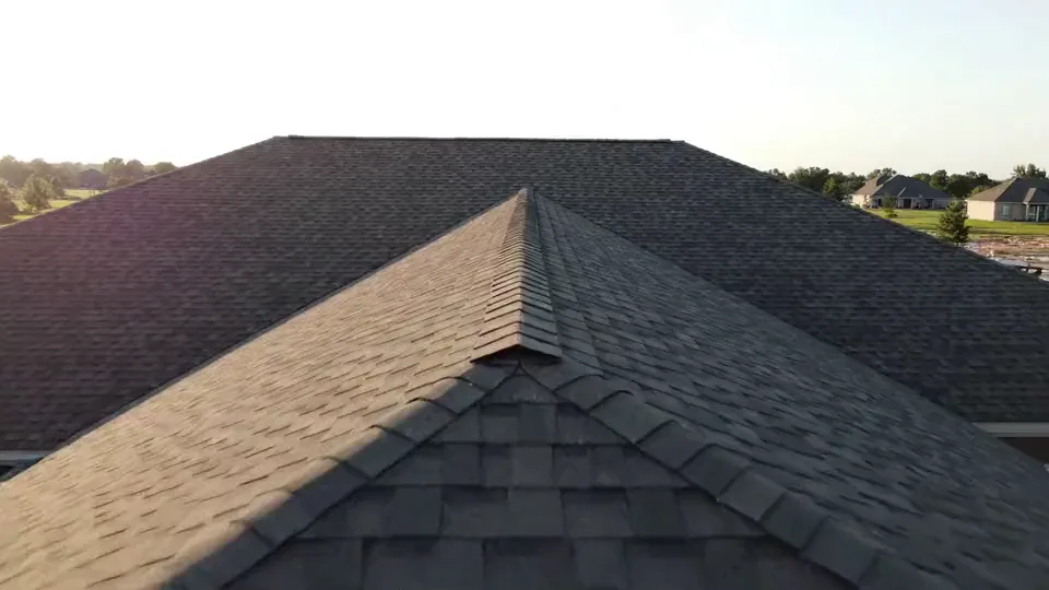 Aerial descent onto a shingle roof ridge