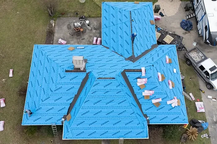 Roof stripped to the deck with blue synthetic underlayment down